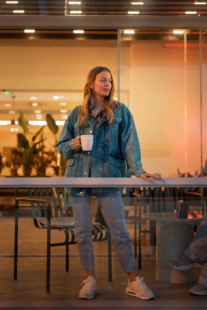 Free photo full shot woman wearing total denim outfit