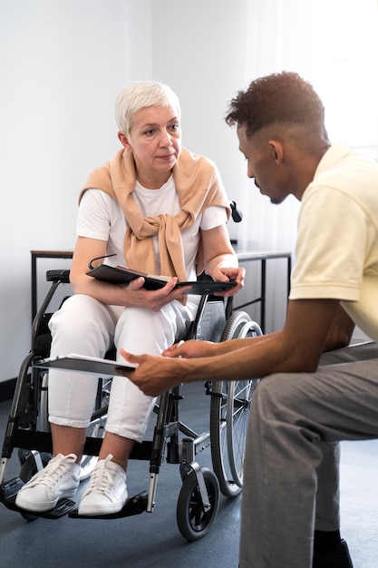 Free photo full shot woman in wheelchair at work