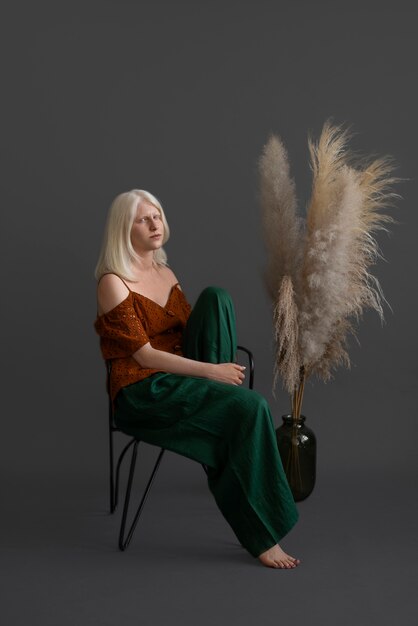 Full shot woman with albinism posing in studio