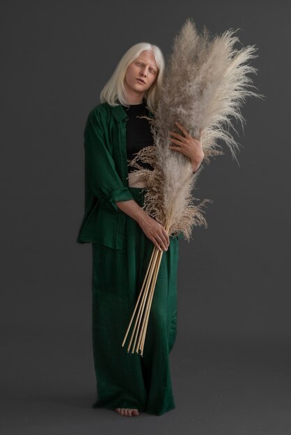 Full shot woman with albinism posing in studio