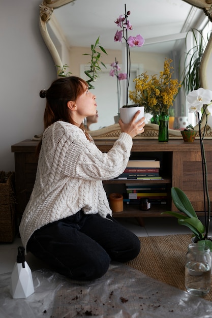 Full shot woman with beautiful flowers