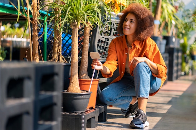 Free photo full shot woman with beautiful flowers