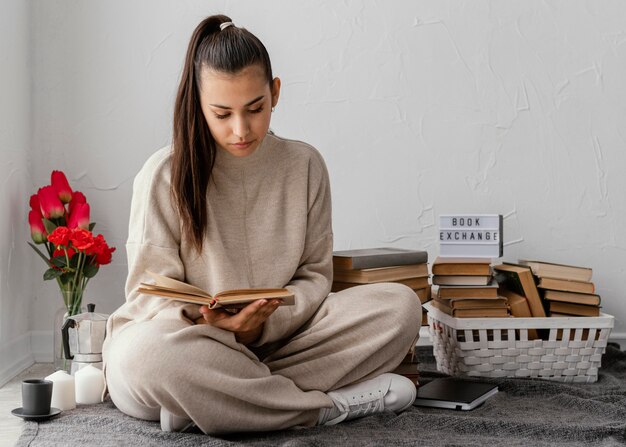 Full shot woman with books and tulips