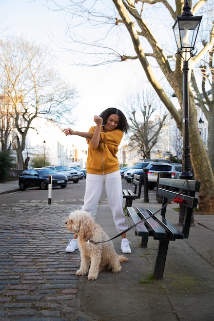 Full shot woman with cute dog outdoors