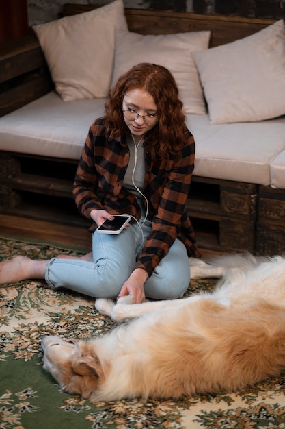 Free photo full shot woman with cute greyhound dog