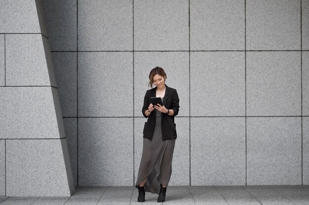 Full shot woman with device