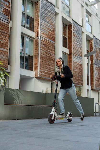 Full shot woman with electric scooter