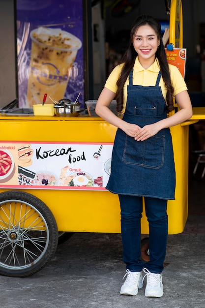 Free photo full shot woman with food truck