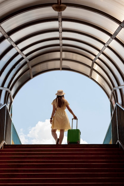 Full shot woman with green baggage