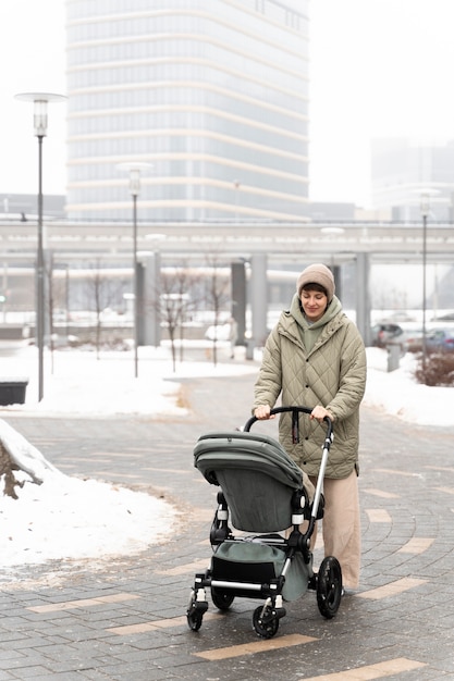 Full shot woman with stroller outdoors