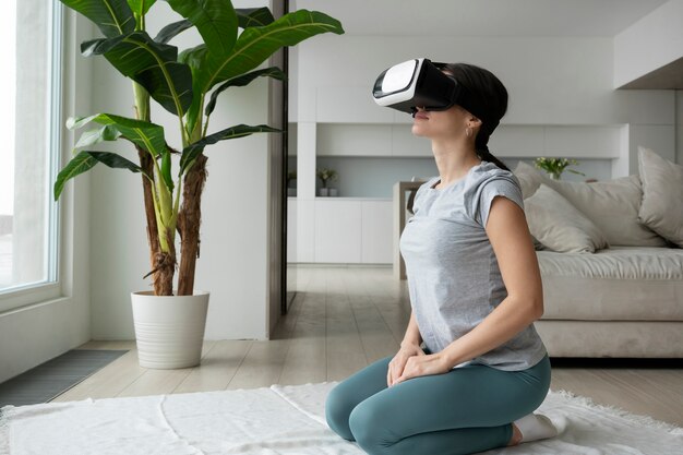 Full shot woman with vr glasses at home