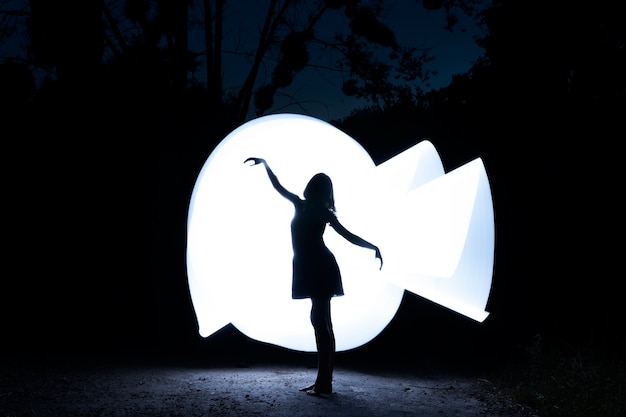 Full shot woman with white light painting