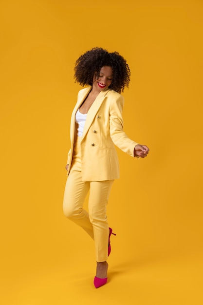 Free photo full shot woman with yellow suit