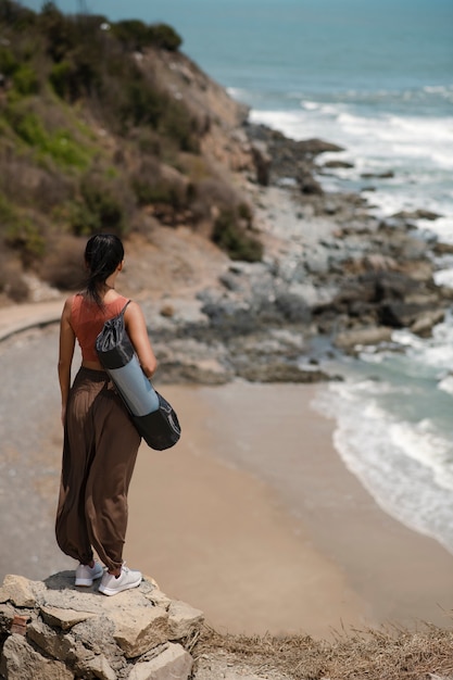 Free photo full shot woman with yoga mat