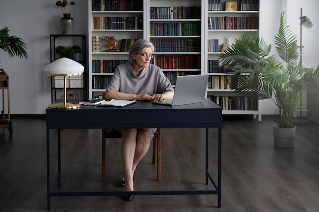 Full shot woman working at desk