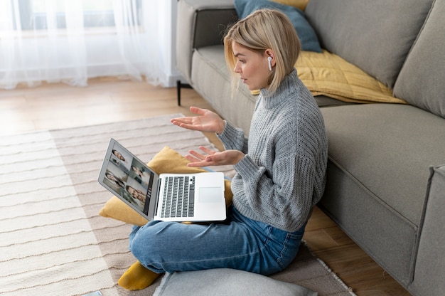 Full shot woman working from home