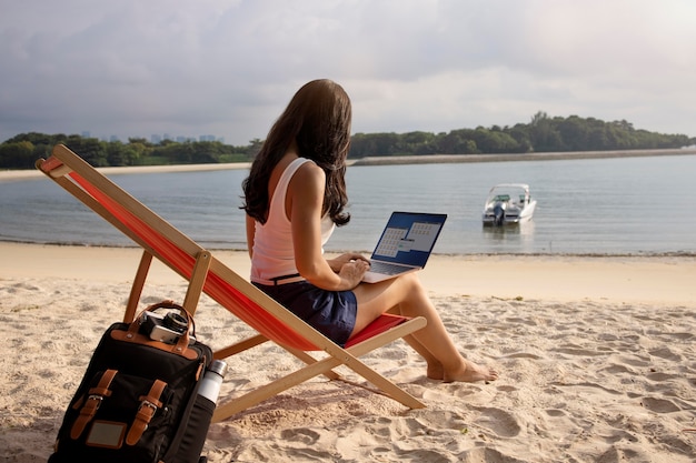 full shot woman working on laptop