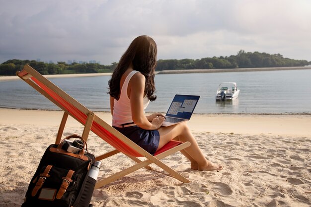 Full shot woman working on laptop