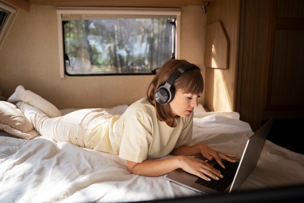 Full shot woman working on laptop