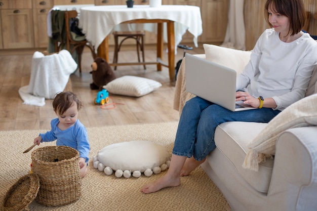 Free photo full shot woman working with baby