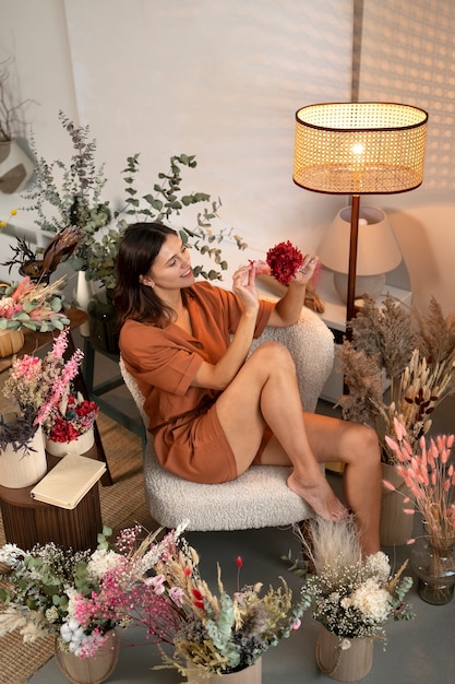 Full shot woman working with flowers