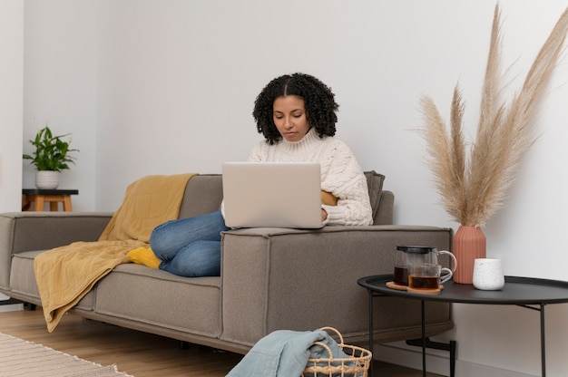 Free photo full shot woman working with laptop