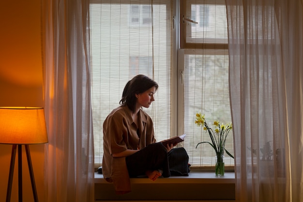 Free photo full shot woman writing in her journal