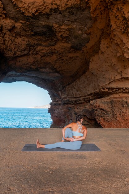 Full shot woman yoga posture with view