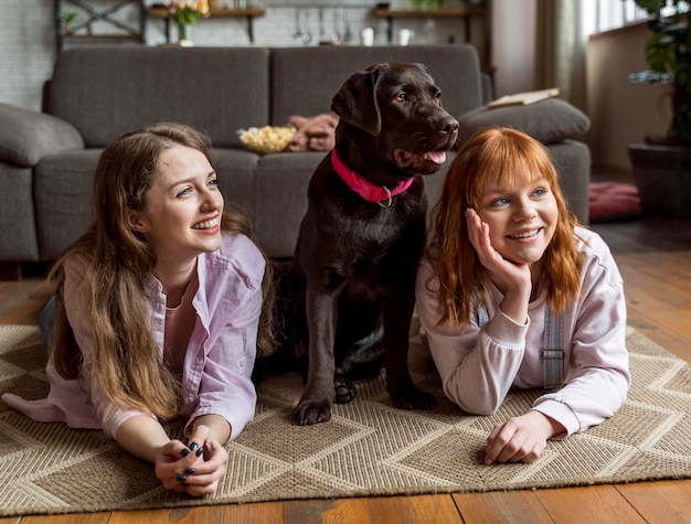 Free photo full shot women and dog indoors