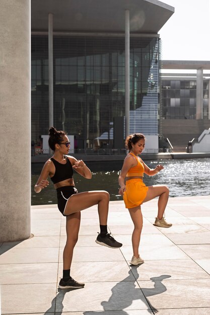 Full shot women exercising together