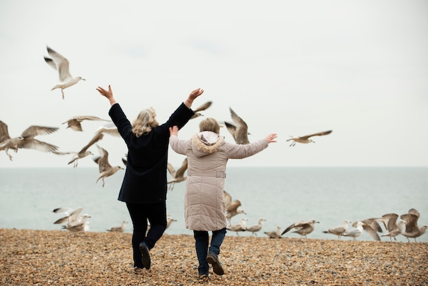 Free photo full shot women outdoors with birds