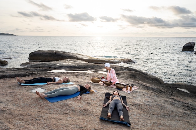 Full shot women retreat at beach