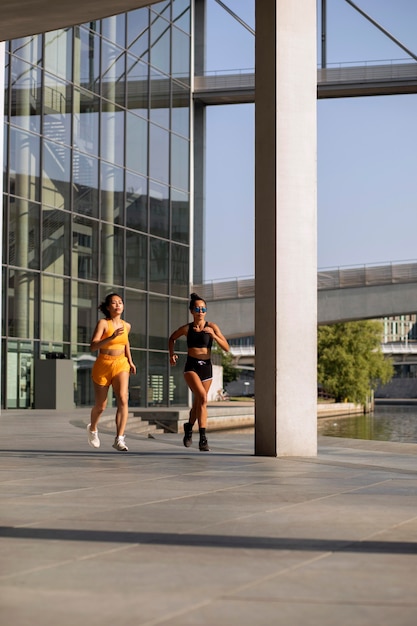 Full shot women running outdoors