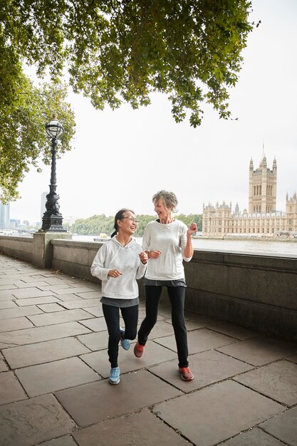 Full shot women running outdoors