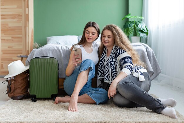 Full shot women sitting on carpet