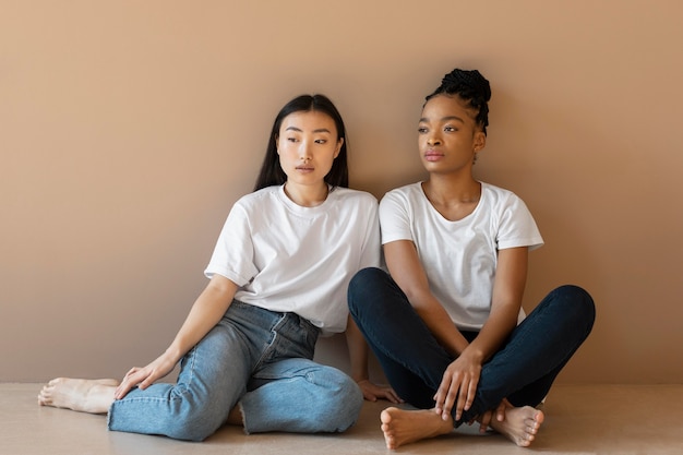 Full shot women sitting on floor