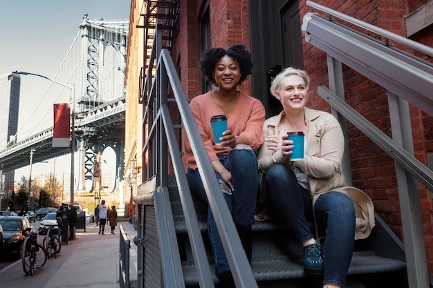 Full shot women sitting on stairs