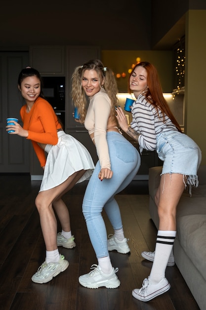 Free photo full shot women twerking at party