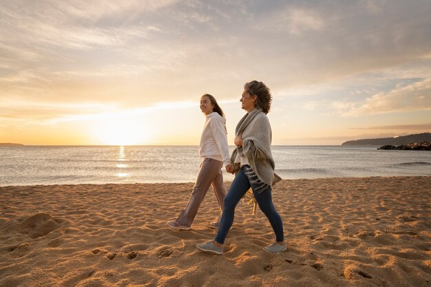 Full shot women walking on beach