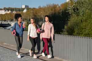 Free photo full shot women walking together