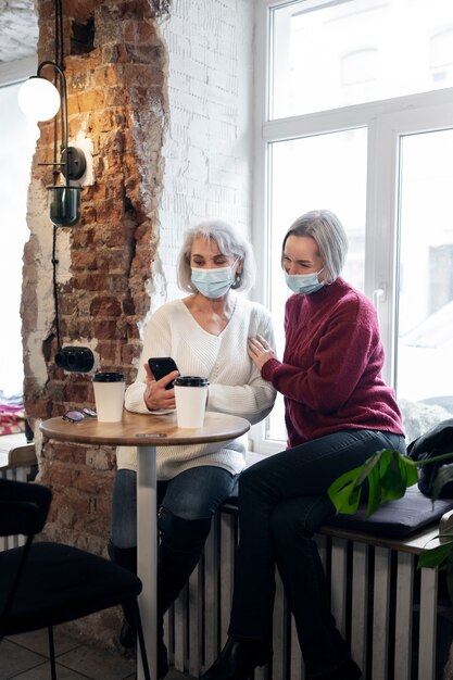 Full shot women wearing face masks