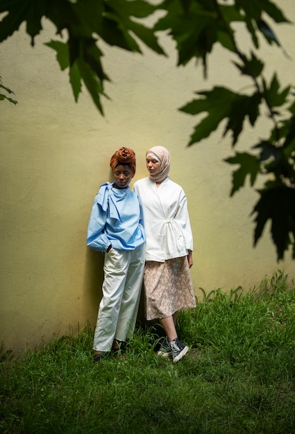 Full shot women wearing hijab outdoors