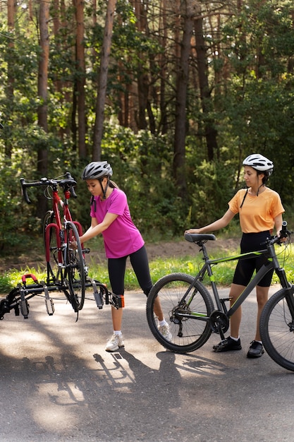 Full shot women with bicycles