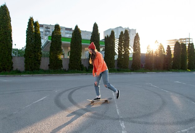 Full shot young girl skating outdoors