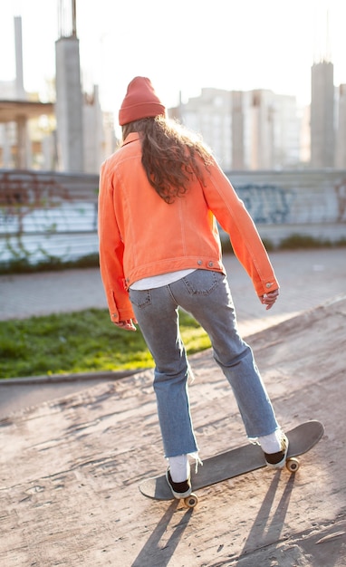 full shot young girl with skate outside
