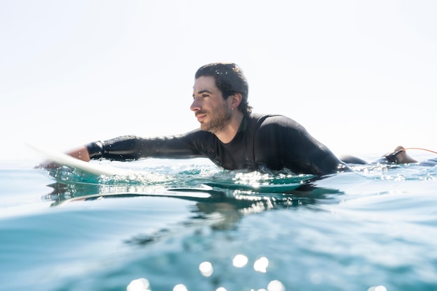 フルショットの若い男サーフィン