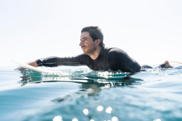 Full shot young man surfing