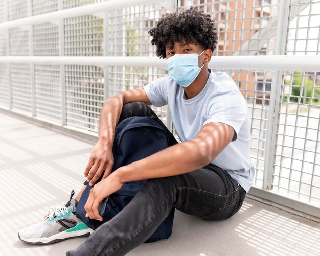 Full shot young man wearing face mask