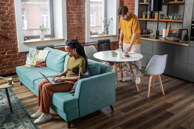 full shot young man and woman at home