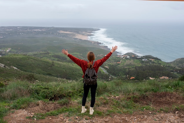 Free photo full shot young woman hiking